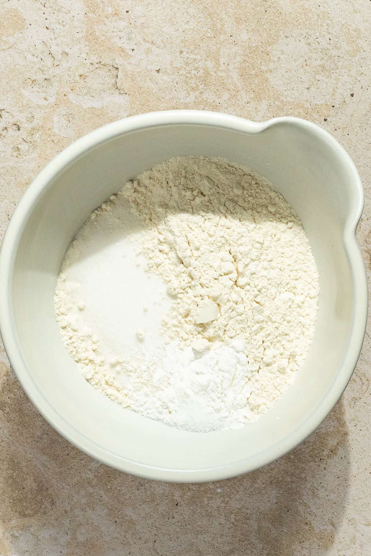 Dry ingredients added to a mixing bowl.