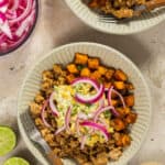 Two street corn bowls with pickled onions.