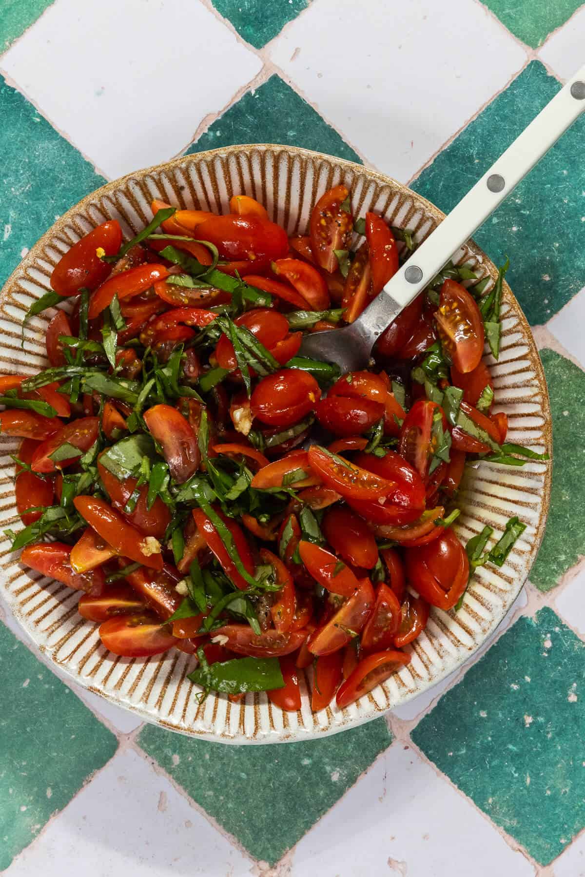 A bowl with the combined bruschetta ingredients.