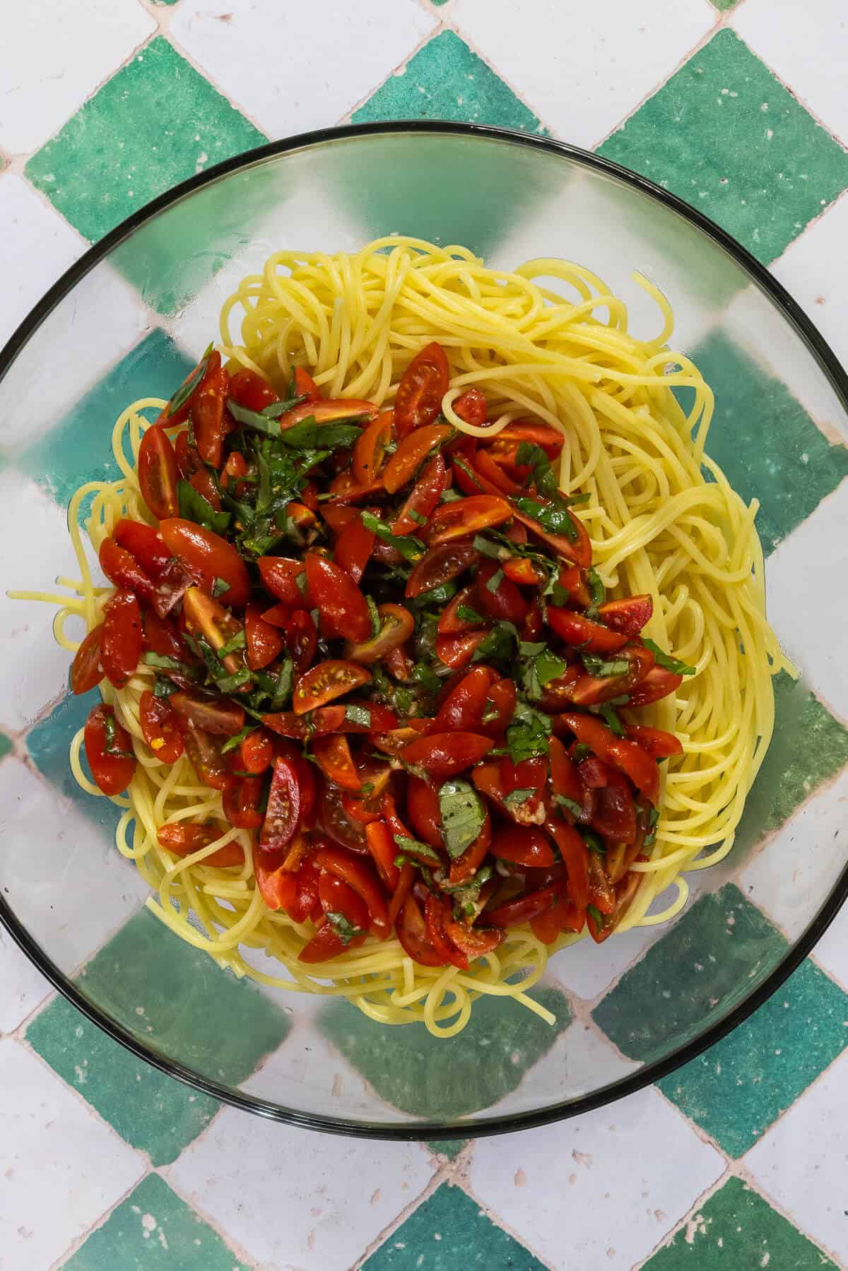 The cooked pasta and bruschetta in a large mixing bowl prior to combining.