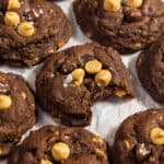 Chocolate and peanut butter chip cookies with a bite taken out of one.