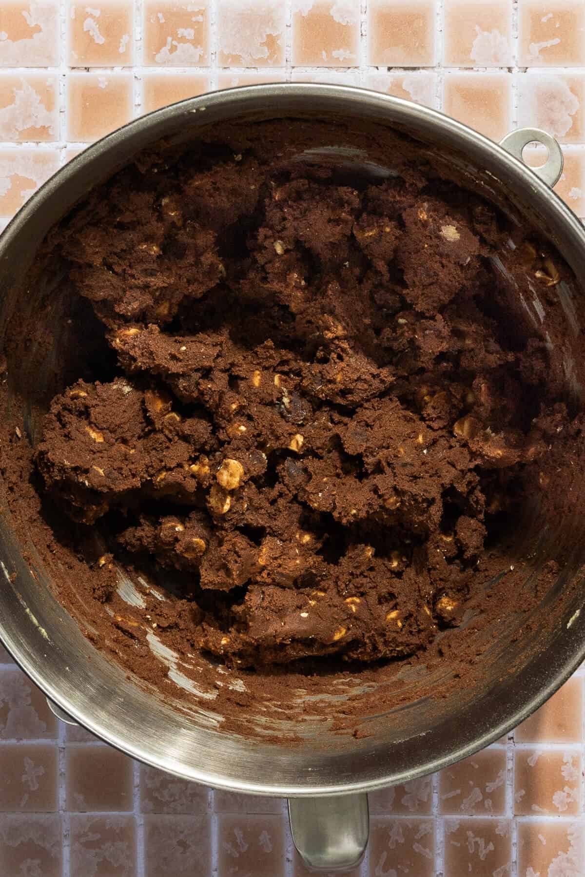 A mixing bowl of chocolate peanut butter chip cookie dough.
