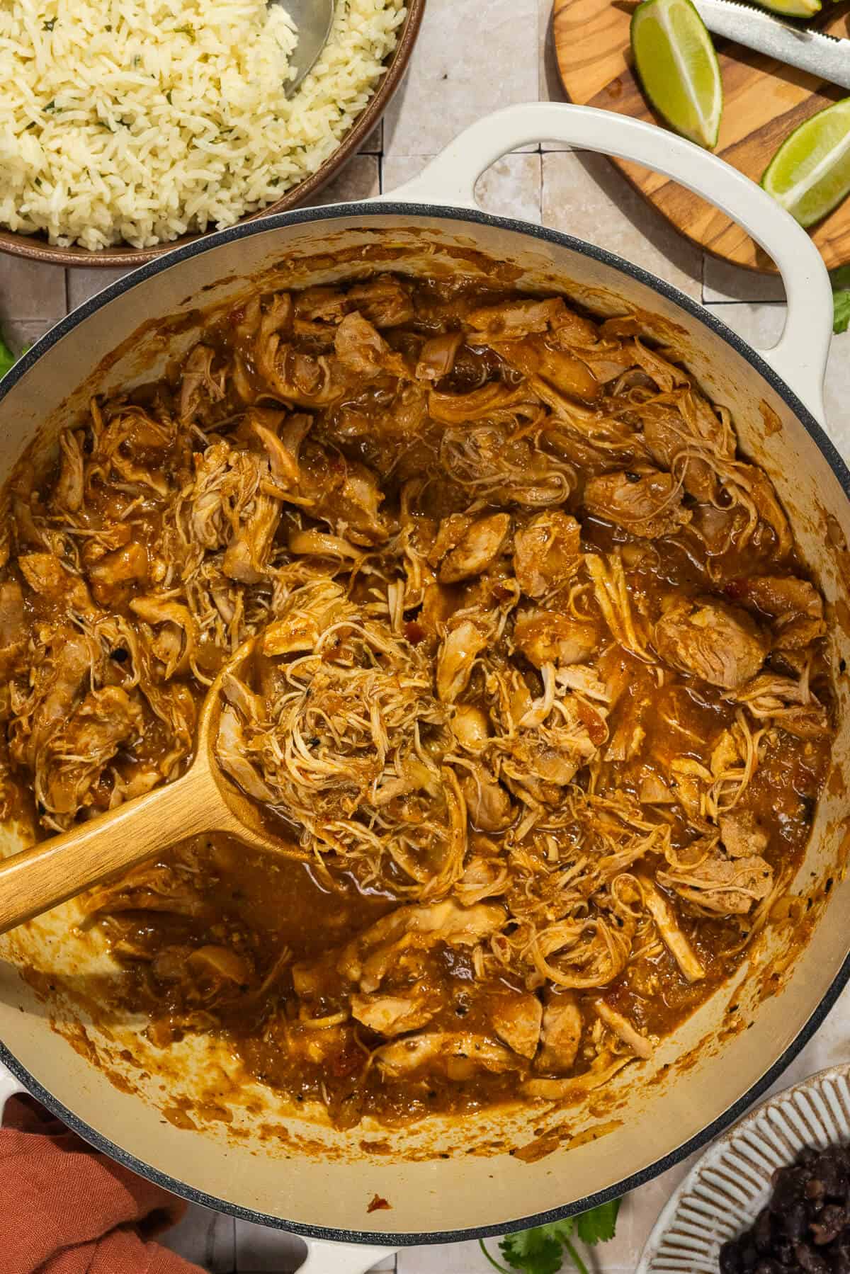 A dutch oven pot with the shredded chicken thighs.