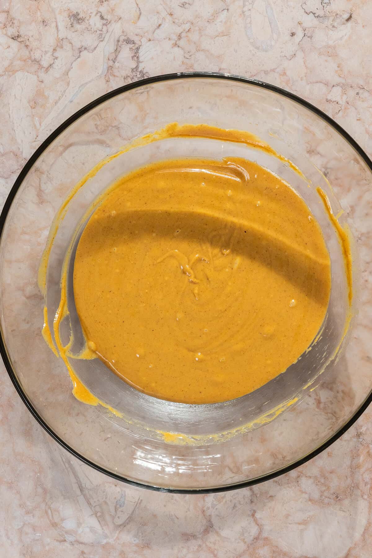 A large mixing bowl with the combined wet ingredients for s'mores protein bites.
