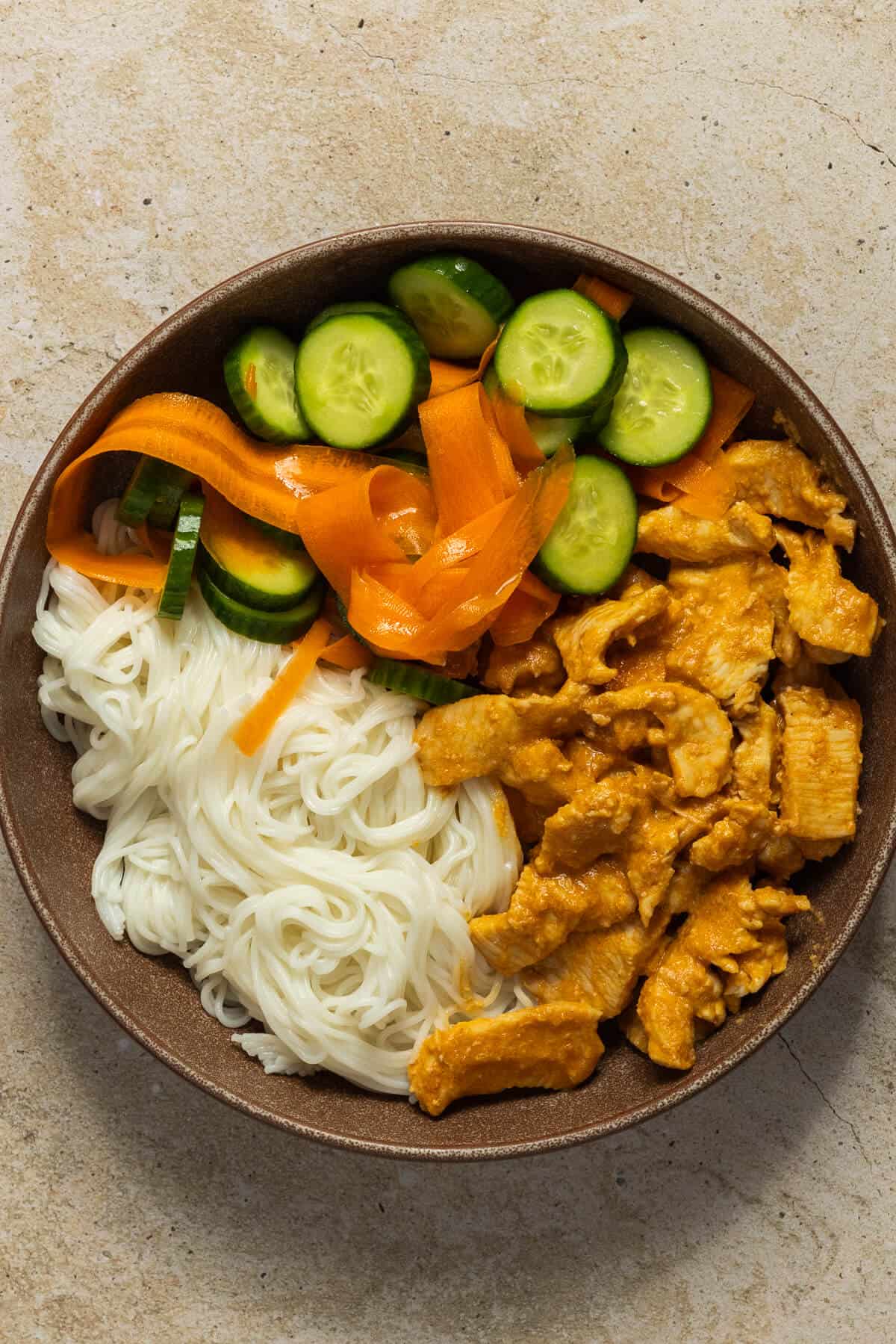 A prepared chicken satay bowl.