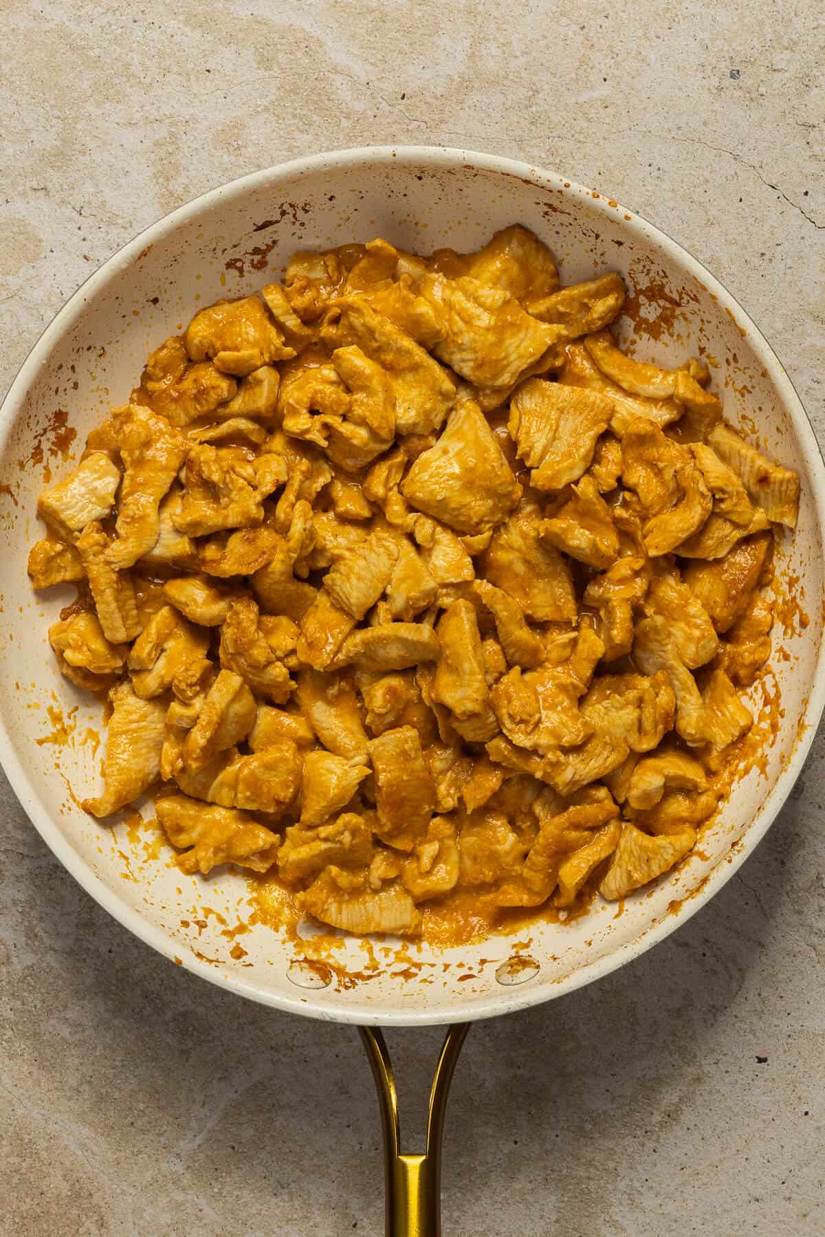 A pan with cooked satay chicken.