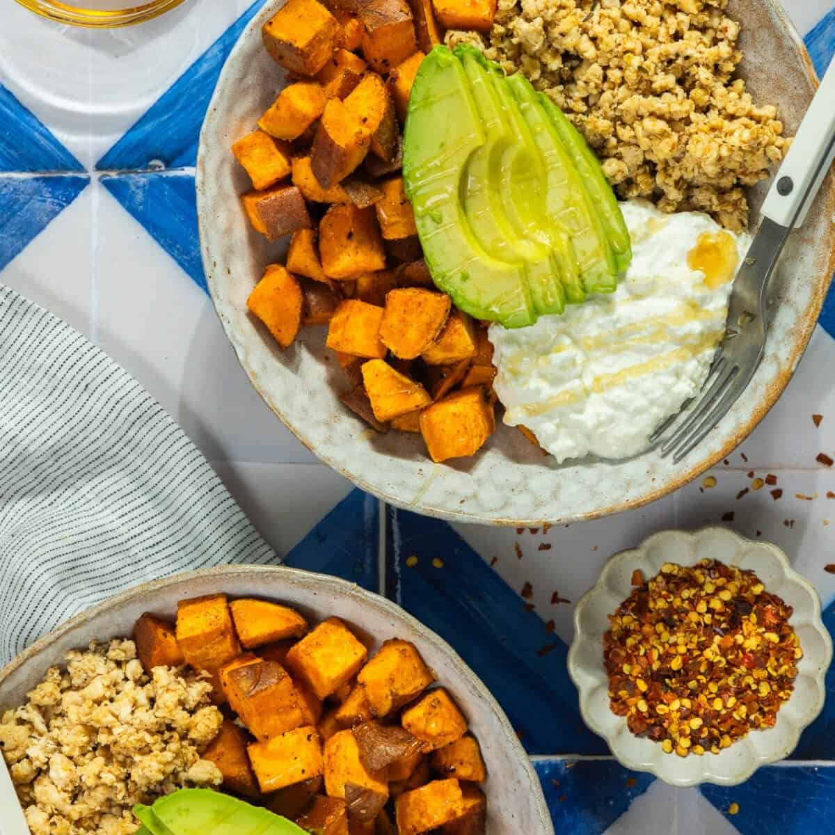 Sweet potato bowl with avocado, quinoa, and yogurt for healthy eating.