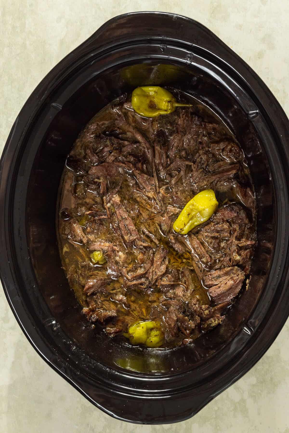 A crockpot insert with prepared Mississippi pot roast.