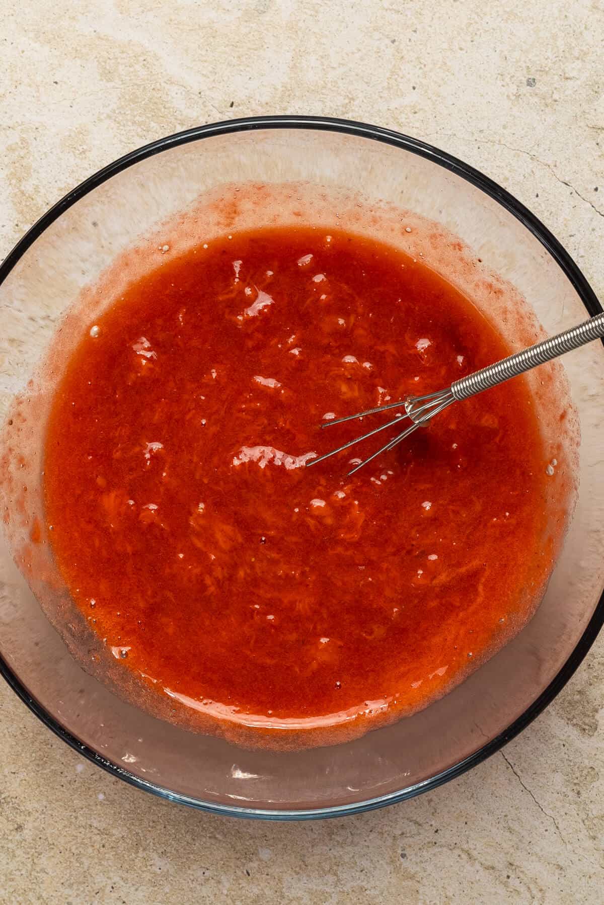 Bowl of mashed strawberries.
