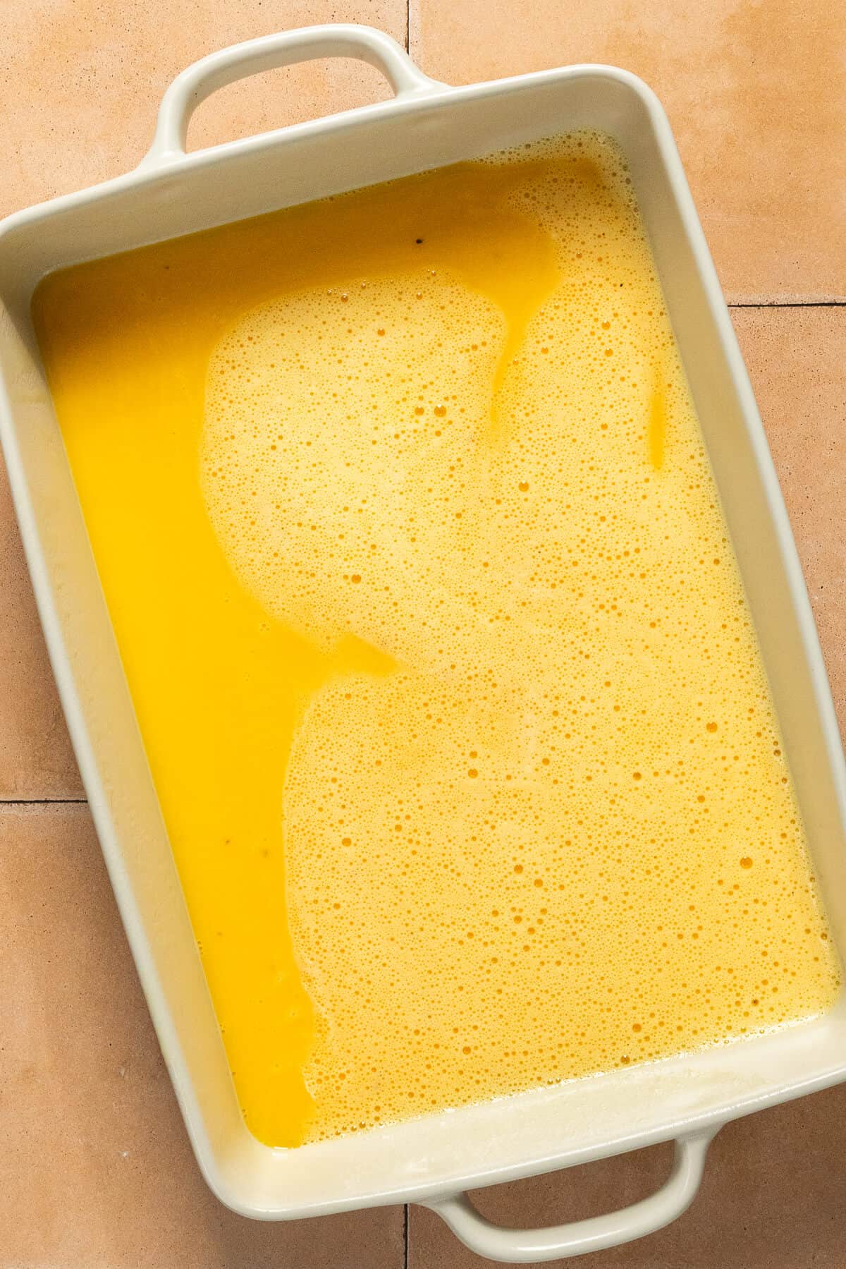 Blended eggs poured into a 9x13 pan.