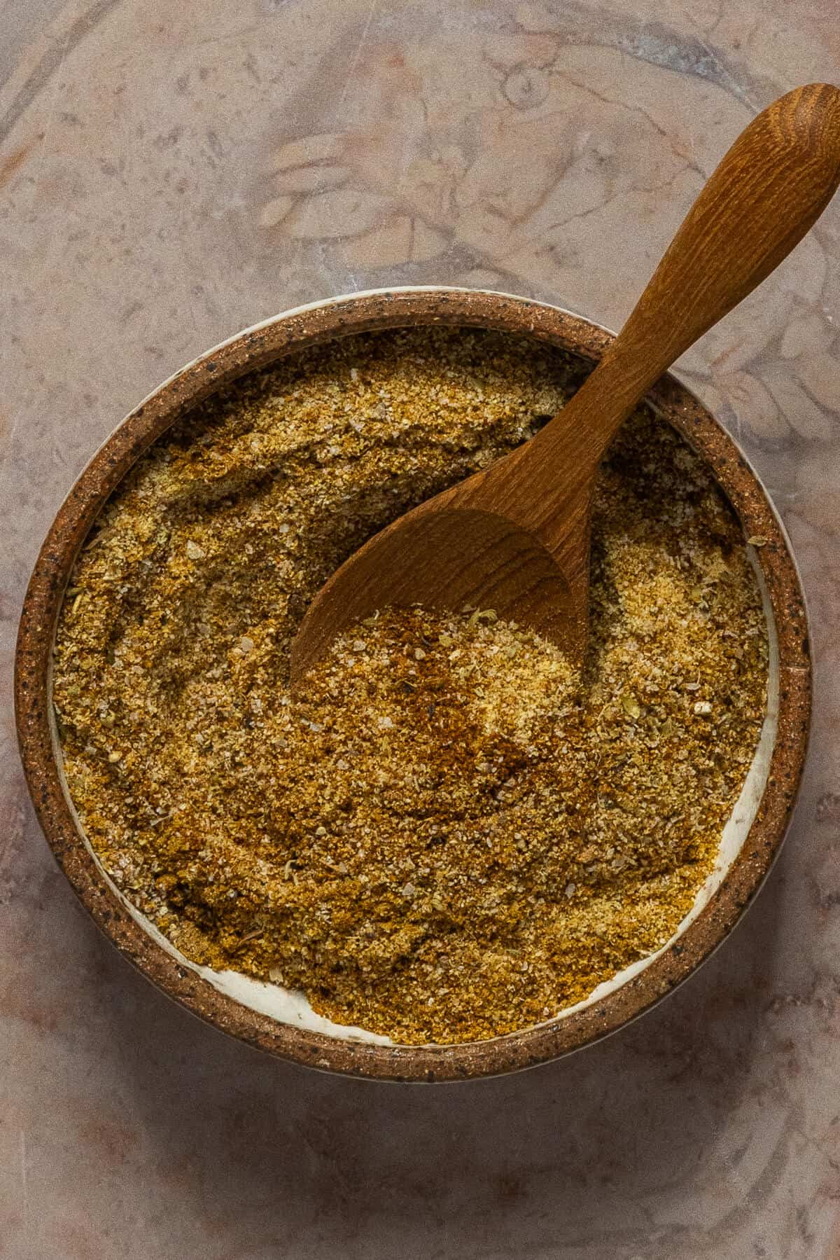 A small bowl with a seasoning blend for the carnitas recipe.