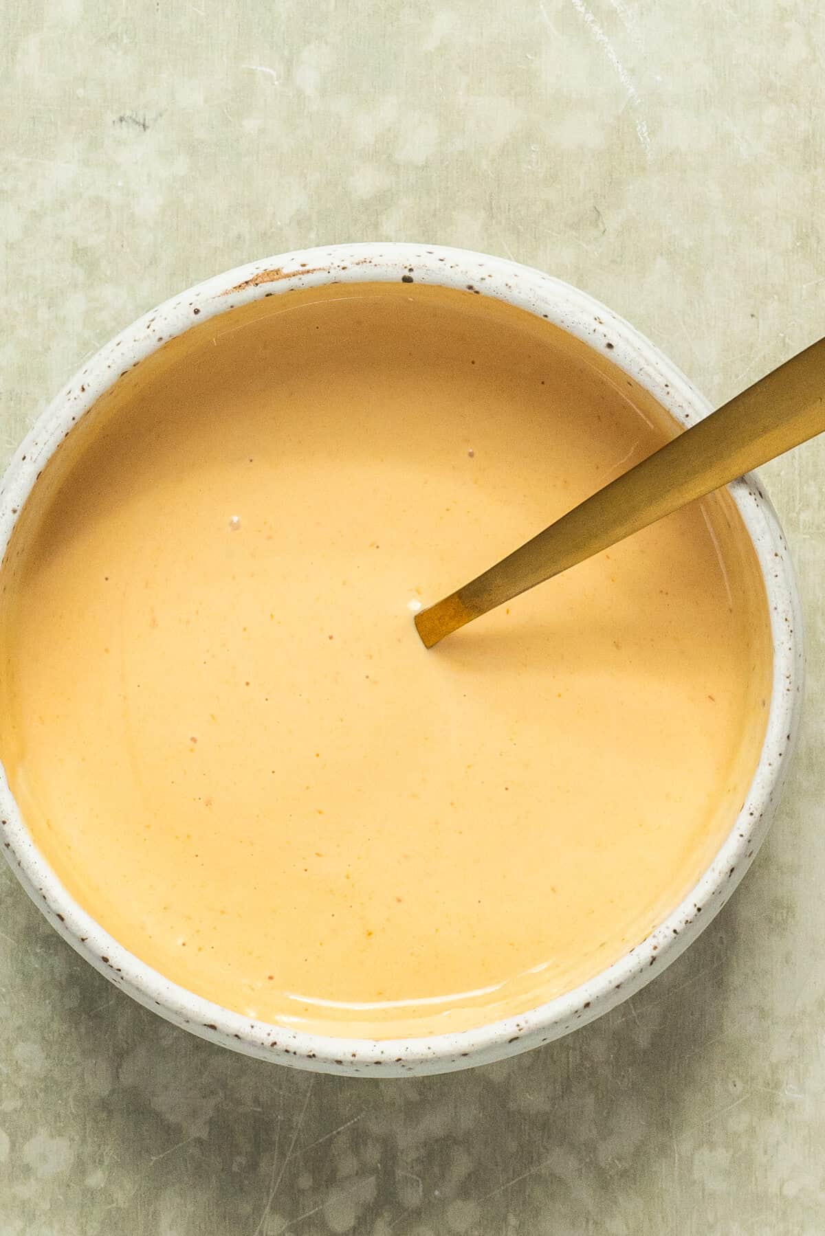 A small bowl with homemade burger sauce.