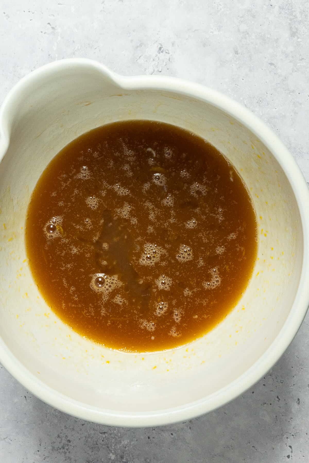 A large mixing bowl with the combined wet ingredients for the muffins.