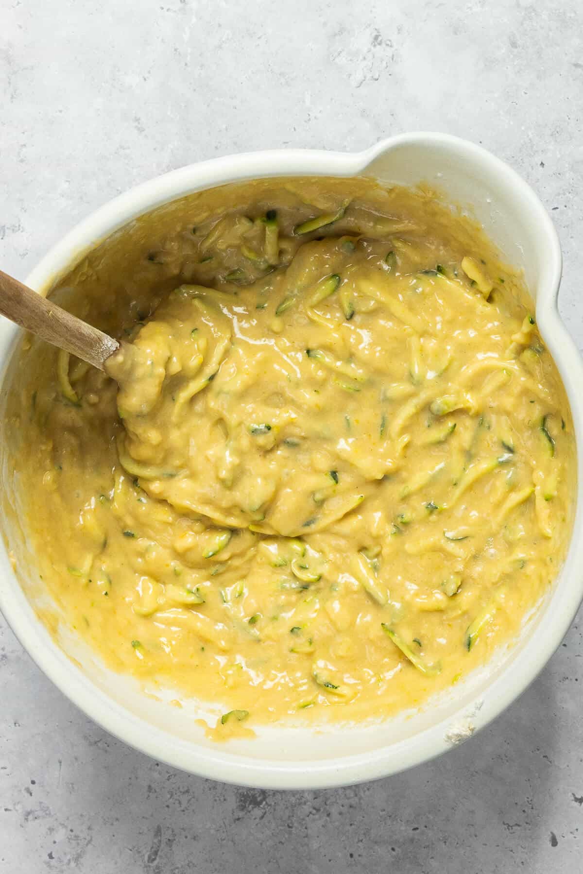 Wet and dry ingredients combined together in a large mixing bowl to make the muffin batter.