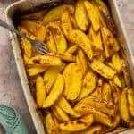 A 9x13 baking dish with the cooked lemon roasted potatoes.