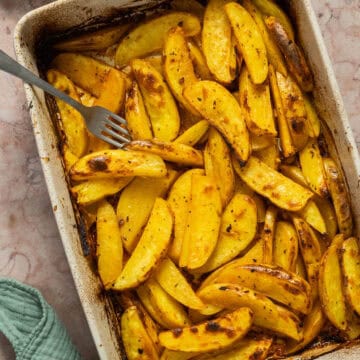 A 9x13 baking dish with the cooked lemon roasted potatoes.