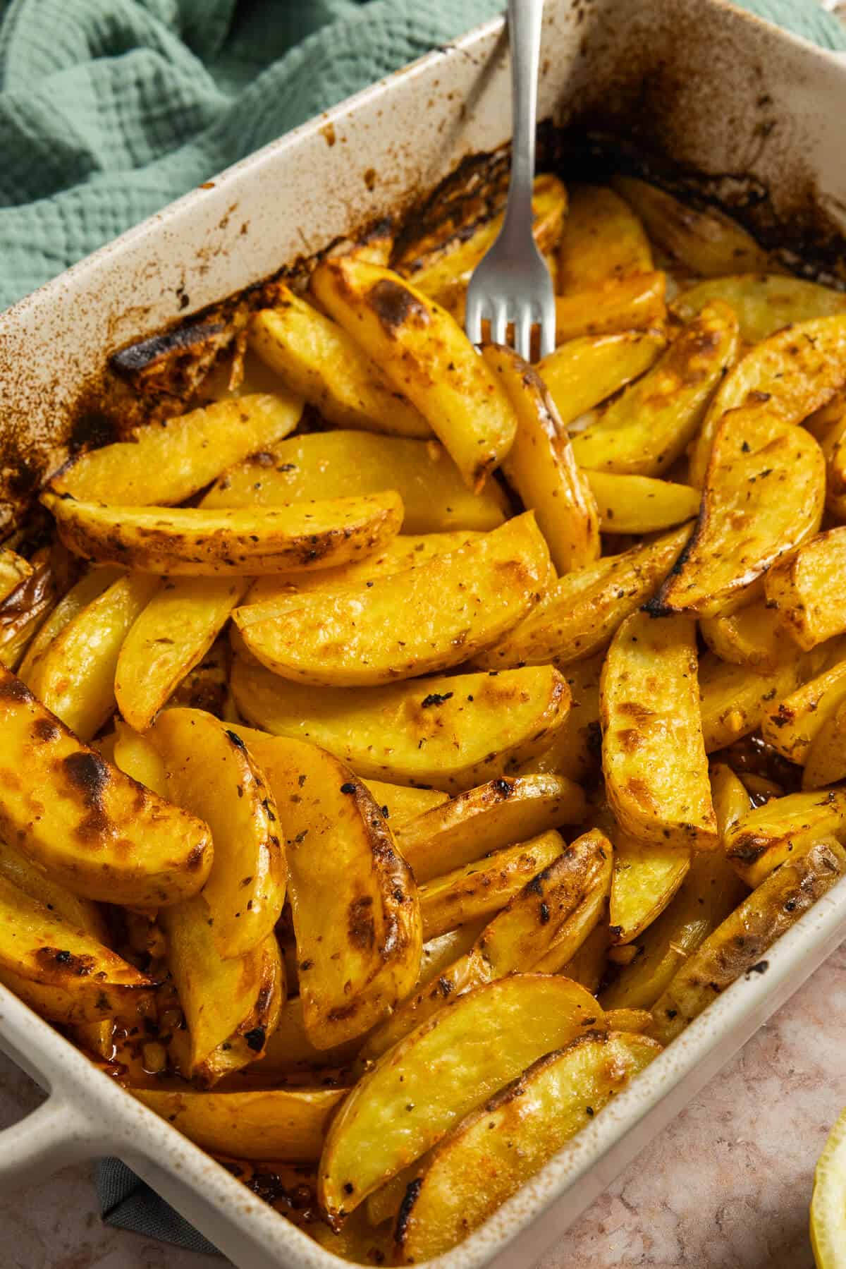 The baked lemon roasted potatoes in a dish.