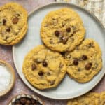 A plate of three oatmeal chocolate chip cookies.