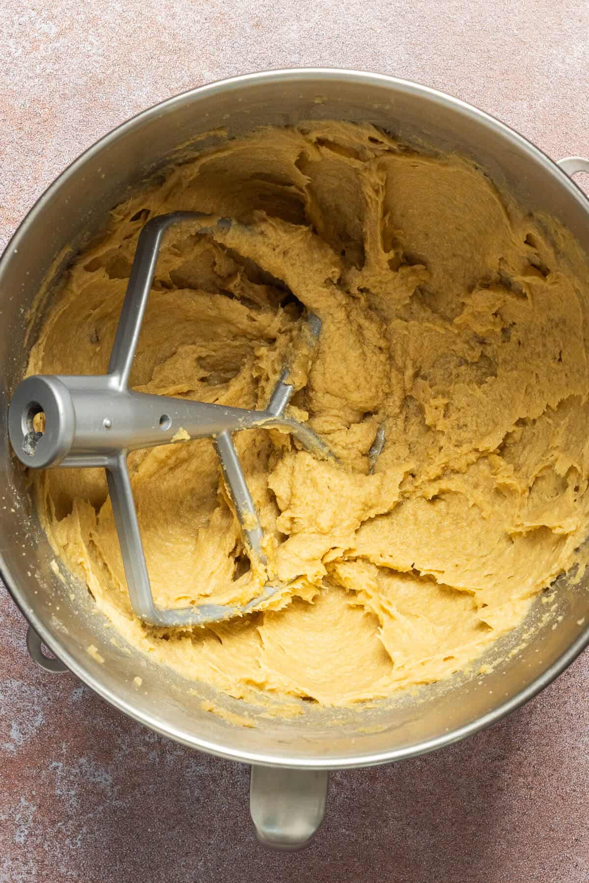 Butter, sugar, vanilla, and eggs combined in a mixing bowl.