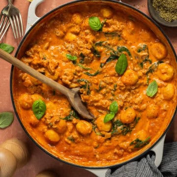 A large skillet of one pan gnocchi with chicken sausage.