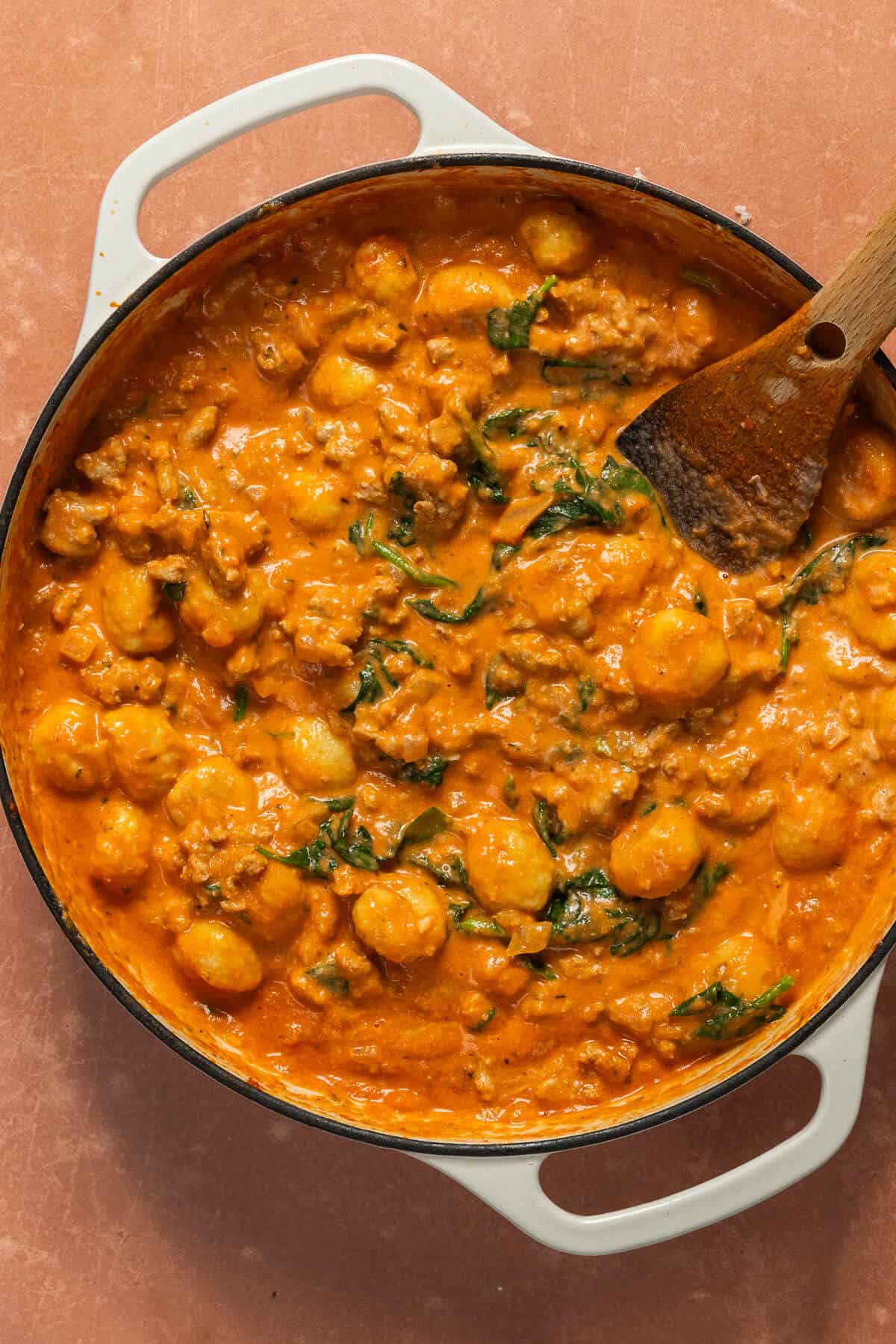 All of the ingredients for one pan gnocchi mixed together in the large skillet.