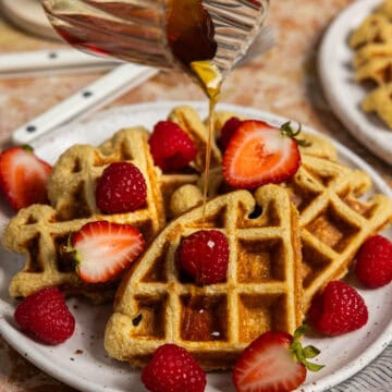 Oat protein waffles with syrup being poured over.