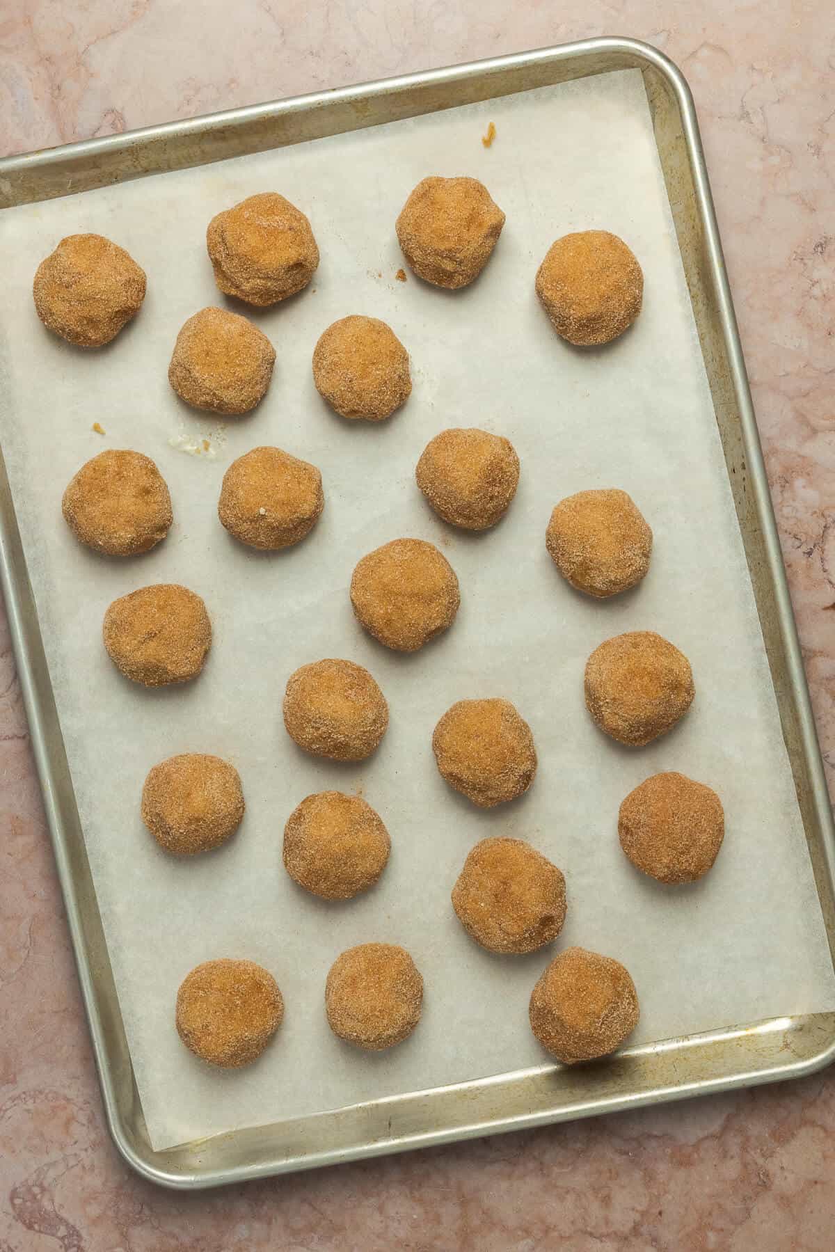 A baking sheet with the snickerdoodle cookie dough balls.