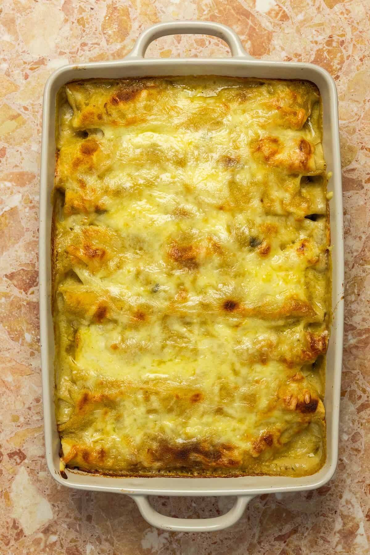 Baking dish of enchiladas after they were taken out of the oven.
