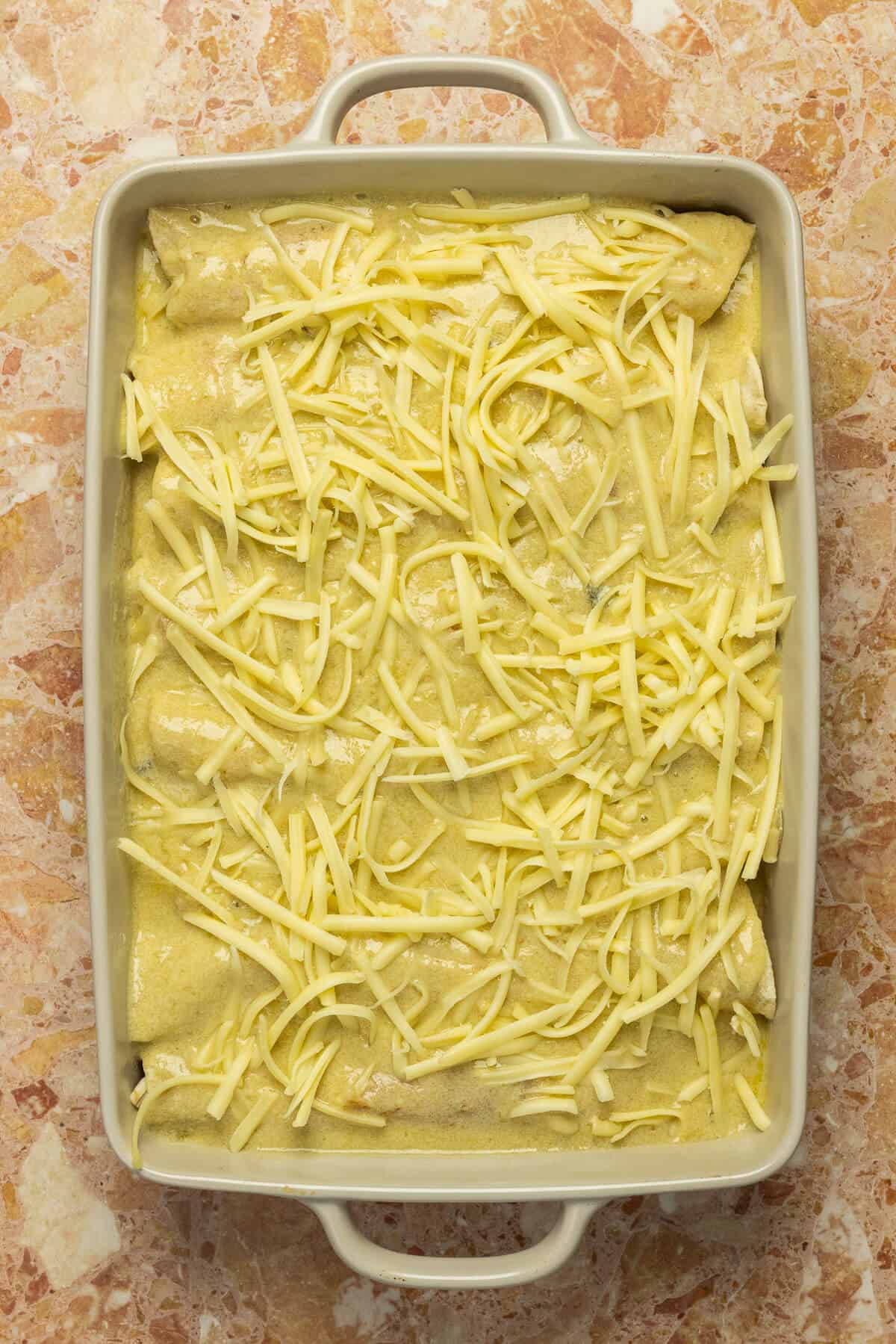 The enchiladas topped with shredded cheese prior to going into the oven.